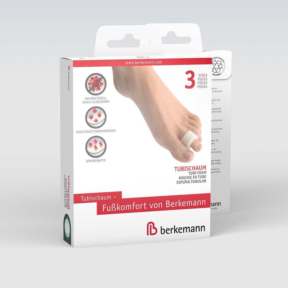 Verpackung des Produkts „Tubischaum – Fußkomfort von Berkemann“. Auf der Vorderseite ist ein Fuß mit einer weißen Schaumstoffhülse auf der Zehe abgebildet. Symbole zeigen die Produkteigenschaften: antibakteriell durch Silberionen, feuchtigkeitsabsorbierend und atmungsaktiv. Enthalten sind 3 Stück Tubischaum.